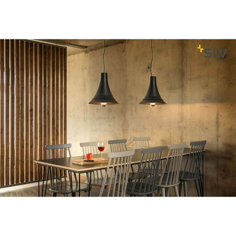 Bato 35 pendant light black above a dining room with wooden furniture and a modern ambiance.