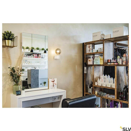 Fitu Cube wall light in a stylish salon with a mirror and shelves for care products.