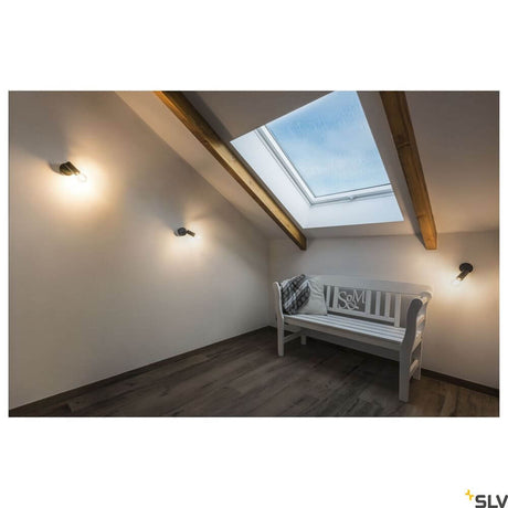 Fitu E27 wall spotlight black on a wall in a modern room with a skylight and bench seating.