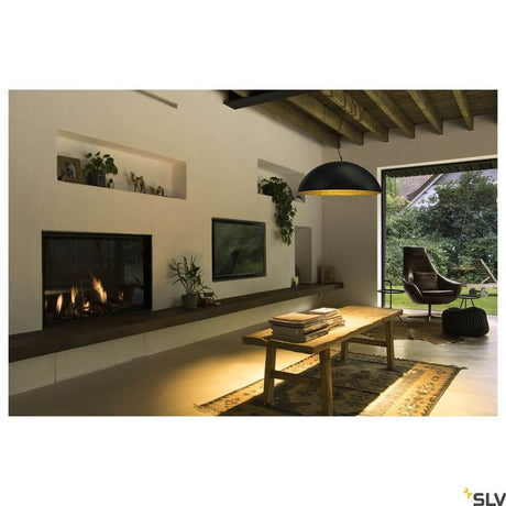 Forchini L 70 E27 pendant lamp black, gold in a modern living room with fireplace.