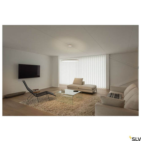 One 80 pendant lamp Dali 3000-4000K white in a modern living room with elegant furnishings.