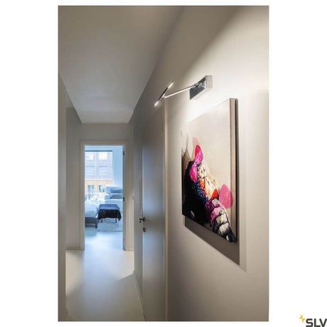 Retrato D wall light 3000K grey illuminates a modern interior with artwork in the hallway.