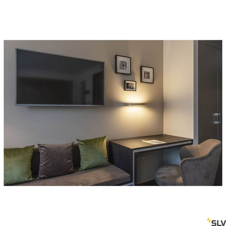 Sedo 7 wall light 3000K Alu in a modern living space with TV and sofa