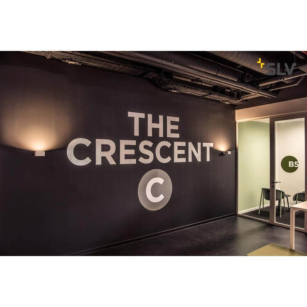 Moderne Wandgestaltung mit Wandleuchten und Schriftzug 'THE CRESCENT' an einer geschmackvollen Wanddeko.