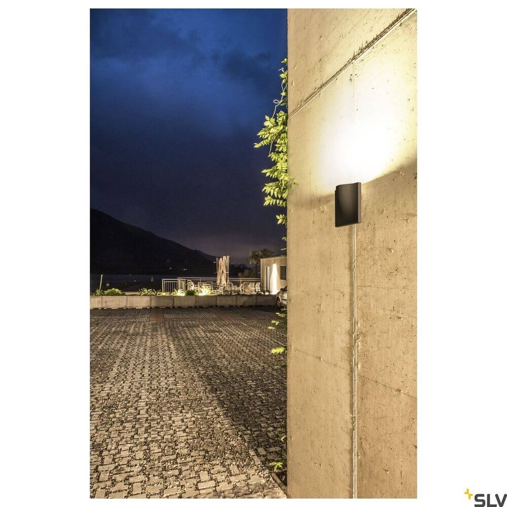 Vilua II LED Wandlampe Anthrazit 3000K IP54 100° 810lm an Betonwand bei Nacht