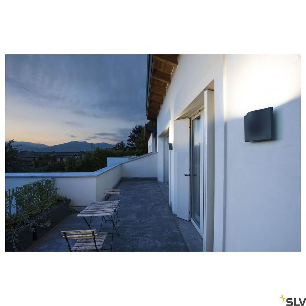 Vilua II LED Wandlampe Anthrazit 3000K IP54 100° 810lm an einer Wand im Freien bei Sonnenuntergang