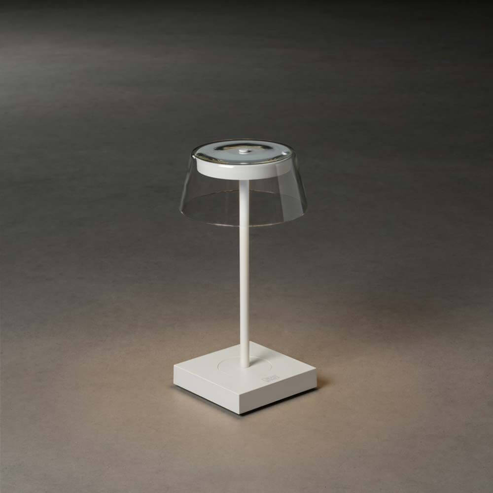 Scilla LED Akku Tischleuchte IP54 im modernen Design mit transparentem Lampenschirm und dimmbarem Licht.