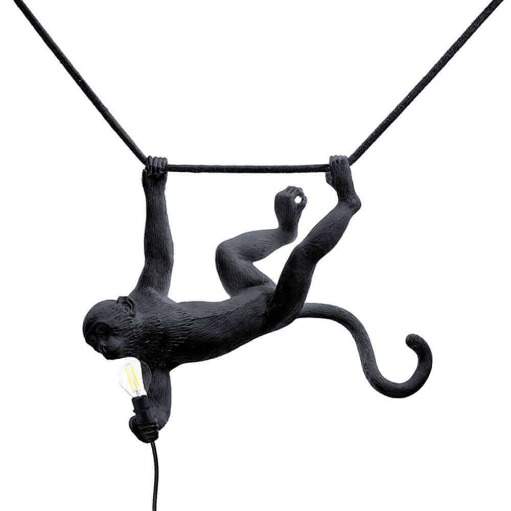 Seletti Monkey Swing Außen-Hängeleuchte in Schwarz mit schaukelndem Affen und Glühbirne.
