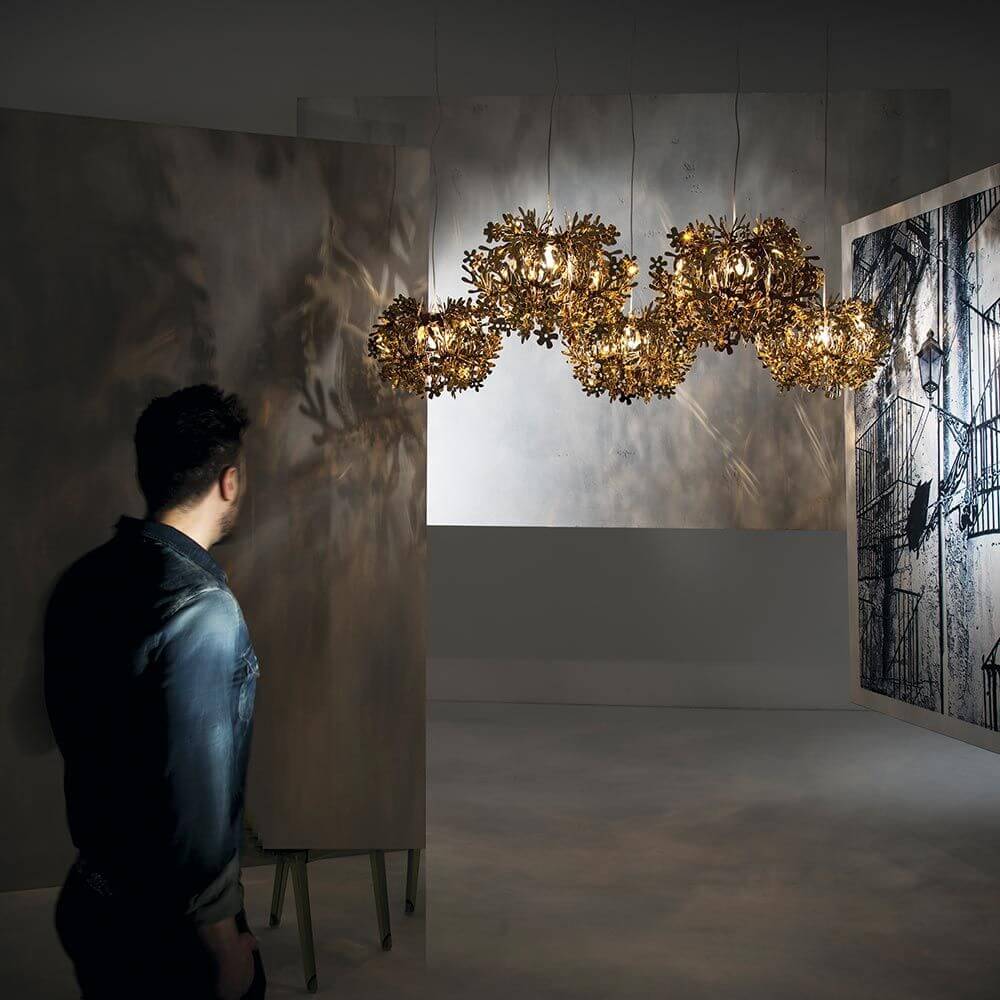 Slamp Hängeleuchte Fiorella Mini Weiß in einem stilvollen Raum mit kunstvollen Lichtreflexionen.