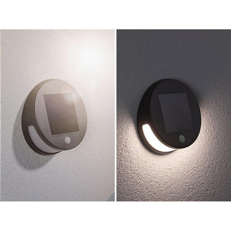 Solar LED Helena outdoor wall light motion sensor anthracite mounted on a wall, with light function activated.