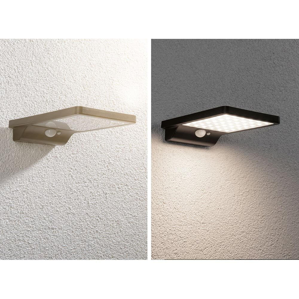 LED Solar Außenwandleuchte Solveig in Schwarz und Beige mit Bewegungssensor an Wand montiert.