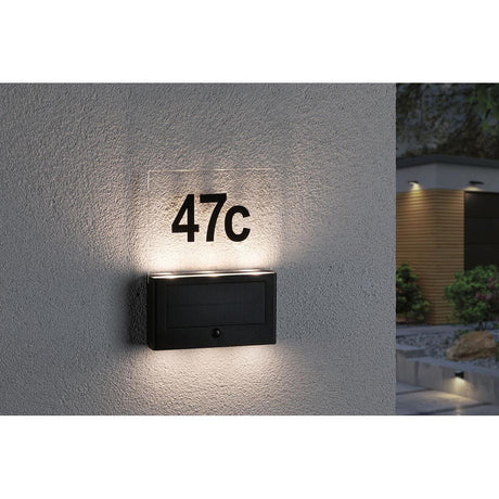 Solar LED house number light Neda Sensor anthracite with illuminated house number 47c mounted on a wall.