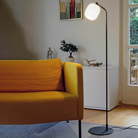 Moderne Wohnzimmeransicht mit der Casablanca Stehlampe Murea Ø 13cm Anthrazit neben einem gelben Sofa.