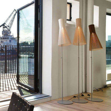 Secto 4210 floor lamps made of wood in a modern room with a view of the harbor.