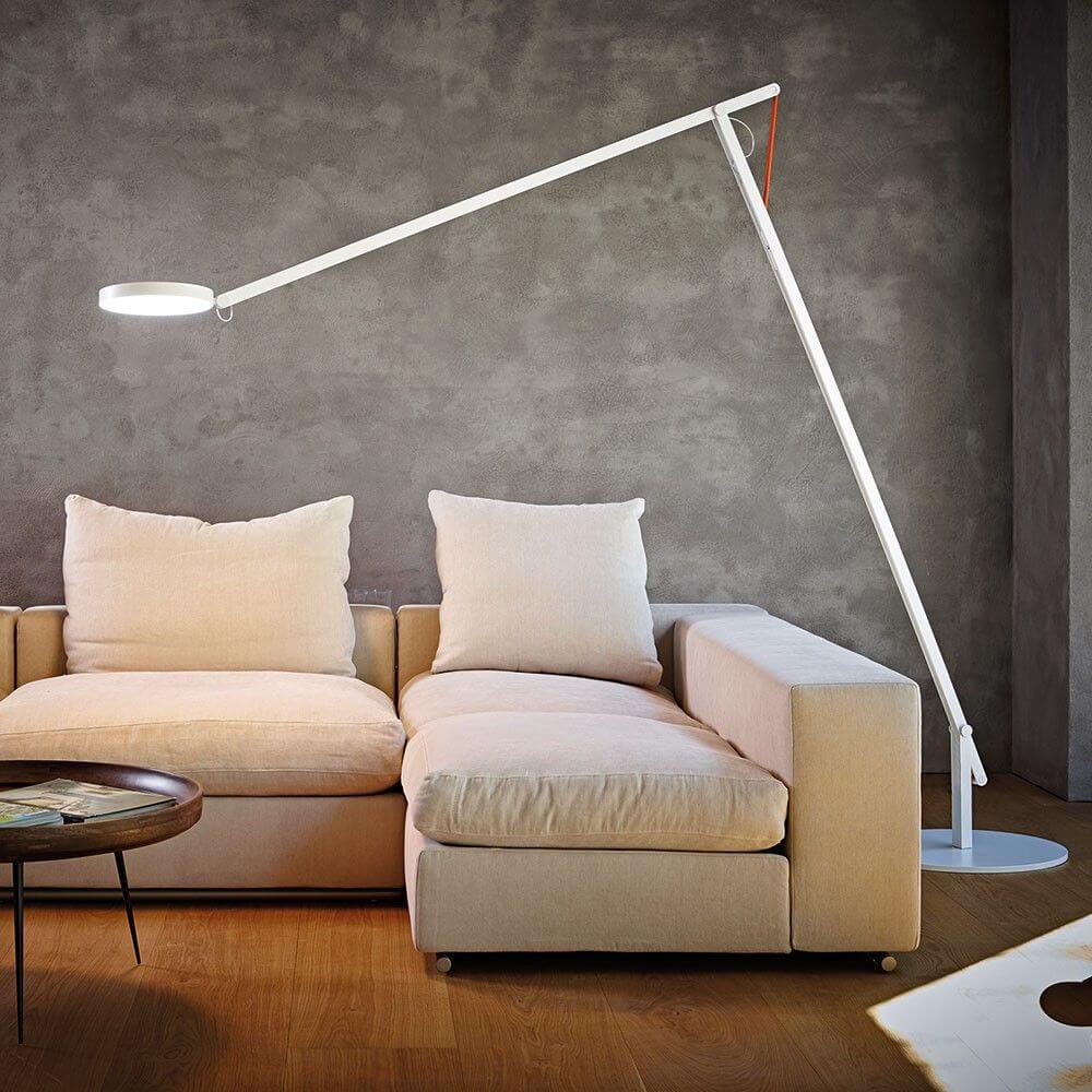 Rotaliana String XL LED floor lamp with dimmer black-orange next to a comfortable sofa in a modern living environment.