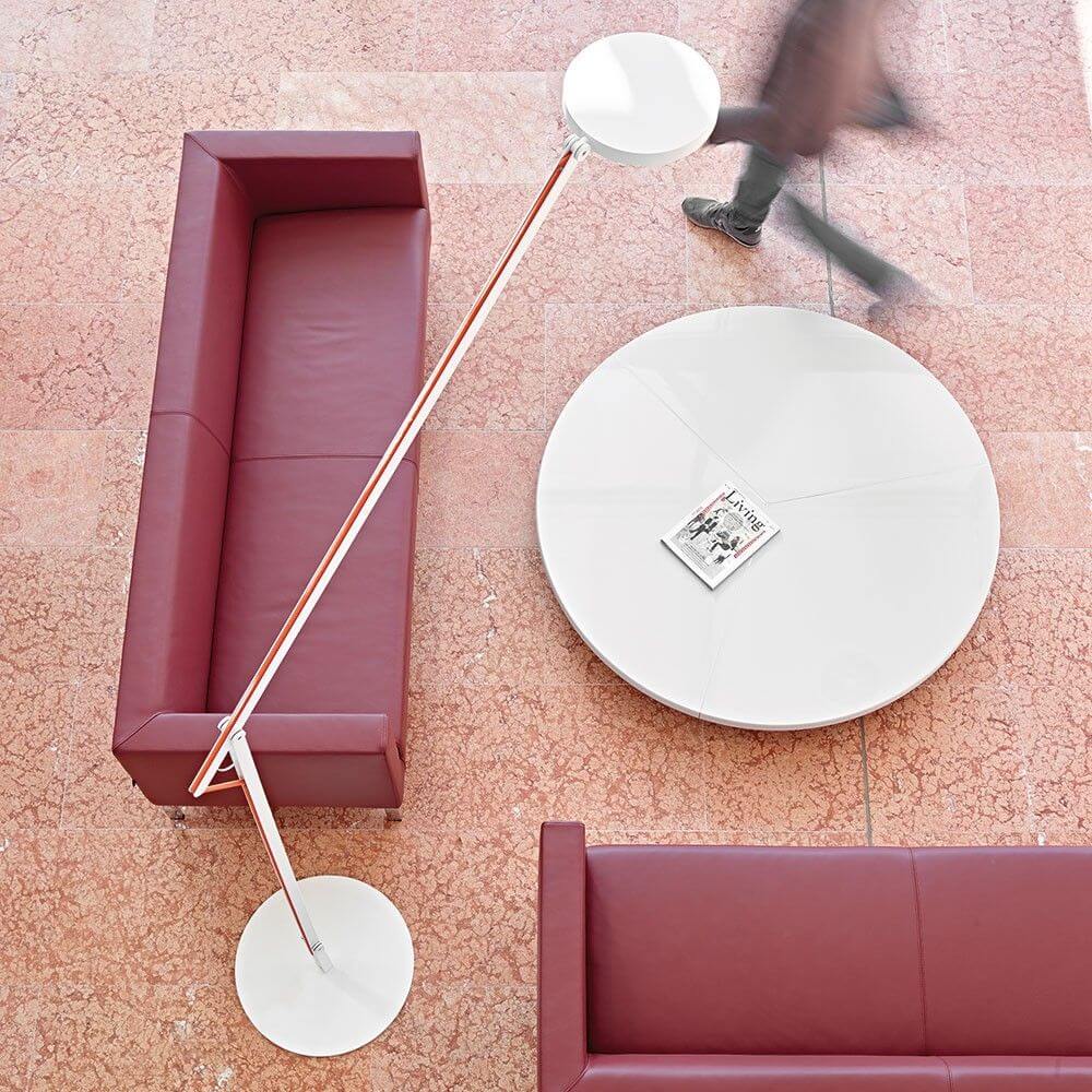 Rotaliana String XL LED floor lamp with dimmer black-orange over a red sofa and round table.