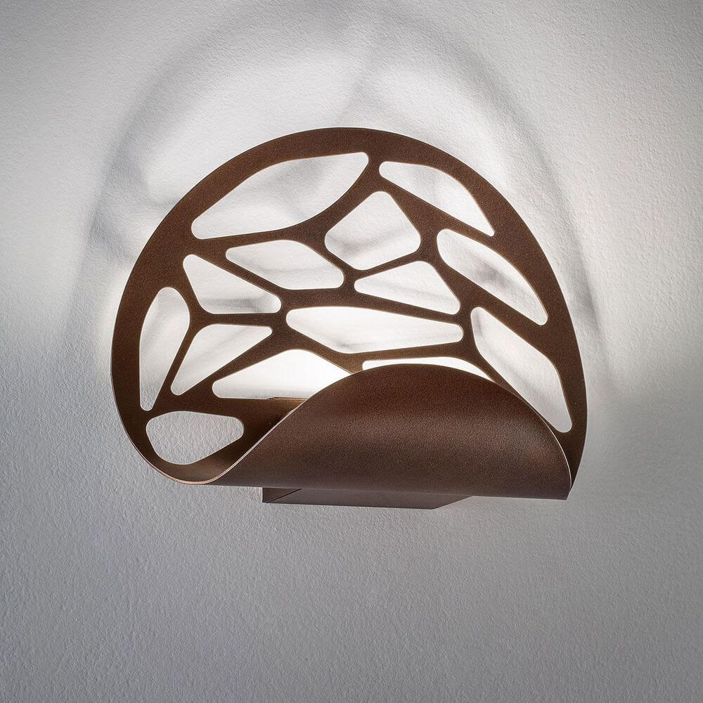 Lodes Kelly Wandlampe mit eleganten Laserschnitten, die Licht und Schatten im Raum zaubern.