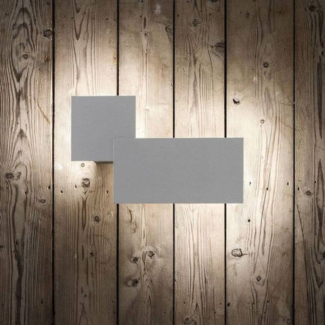 Lodes Puzzle Outdoor Square & Rectangle LED wall light on a wood-paneled wall for atmospheric light in the outdoor area.