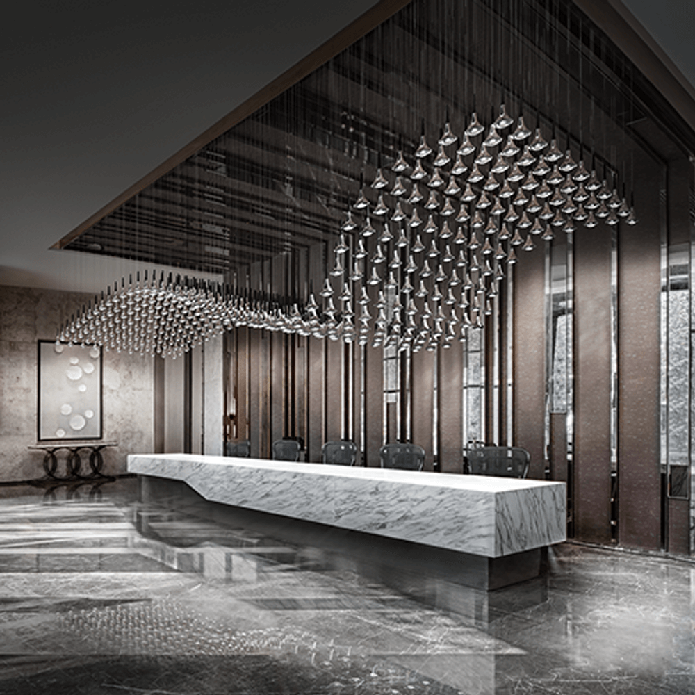 Moderne Empfangshalle mit Lodes Rain LED Hängelampe, eleganter marmorierter Empfangstresen und stilvolles Design.