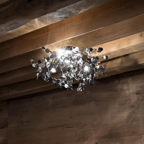 Plafonnier design Terzani Argent avec des disques métalliques diffusant une lumière douce.
