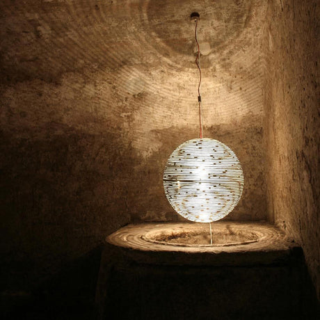 Terzani Magdalena Design-Hängeleuchte in einem rustikalen Raum, erzeugt Licht- und Schattenspiele.