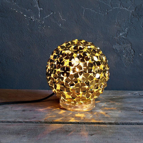 Terzani Orten'zia designer table lamp with hand-soldered flower petals in a gold finish on a wooden base.