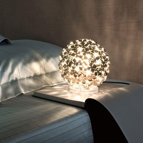 Terzani Orten'zia designer table lamp on a bedside table with soft light.