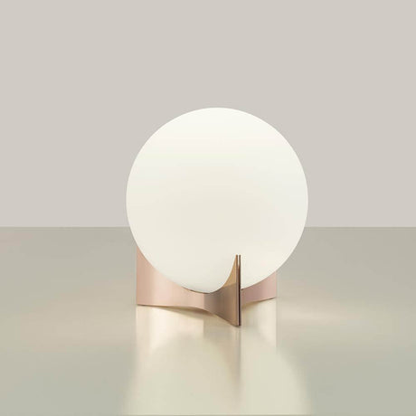 Terzani Oscar design table lamp with white glass and an elegant metal base on a table.