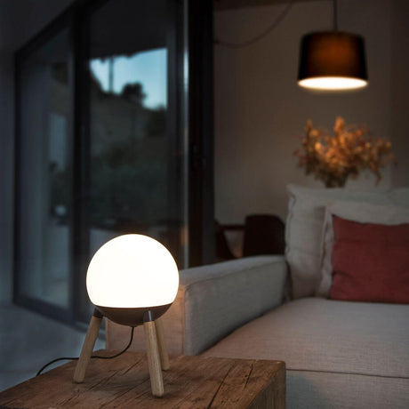 Table lamp Mine White, Dark Grey - Red Dot Award 2018 on a wooden table in a modern room.