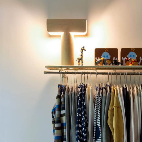 Table lamp Teelo 8020 made of wood 38 cm on a shelf with clothes and toys.
