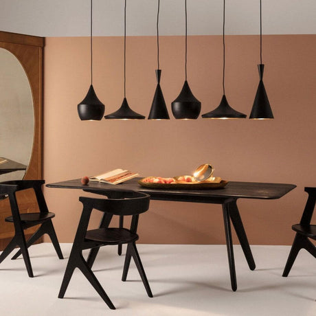 Tom Dixon Beat Range Pendellampe 6er 156cm in stilvollem Esszimmer mit schwarzem Tisch und Holzstühlen.