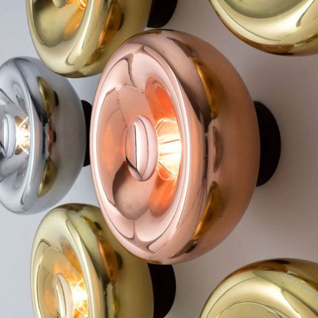 Tom Dixon Void Wandleuchte verspiegelt Ø 30cm in Kupfer, Silber und Gold an der Wand montiert.