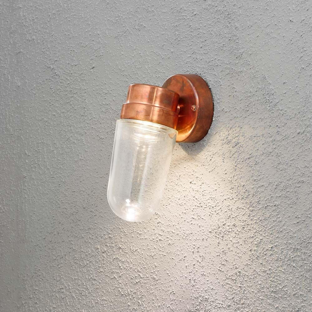 Vega LED Außen-Wandleuchte 700lm , 3000K massives Kupfer, klares Glas an einer Wand montiert.