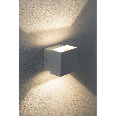 Surface-mounted wall light LED Cybo square 2x3W white 100x100mm on a wall with light accents.