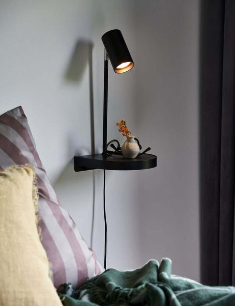 Cody wall light on a wall, minimalist with shelf and adjustable light, ideal for bedrooms.