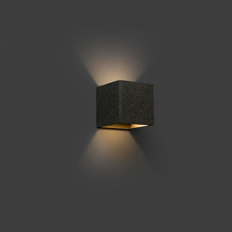 KAMEN wall light in concrete look with modern design and a warm light effect.
