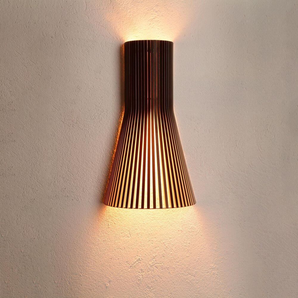 Wandleuchte Secto Small 4231 aus Holz 45cm an Wand montiert mit warmem Licht.