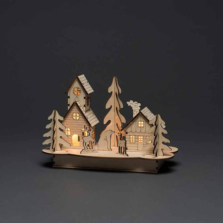 Weihnachtliche Dekoleuchte mit Haus und Tieren aus Holz Braun auf einem dunklen Hintergrund.