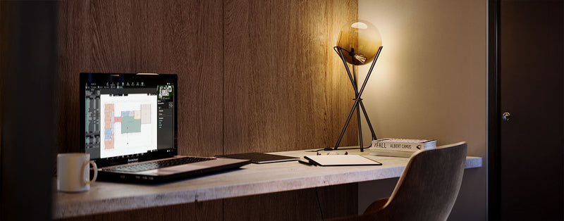 Moderne Schreibtischansicht mit Laptop, Notizen und eleganter Lampe in stilvollem Raum.