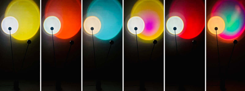 Fünf verschiedene Farbtöne von Lichtprojektionen auf einer Wand durch eine moderne Lampe.