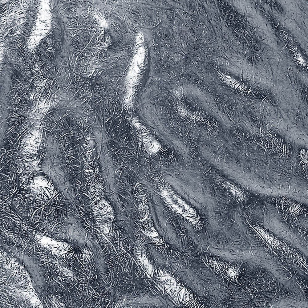 Texturierte Oberfläche in mattem Silber mit strukturierten Linien und Wellen.