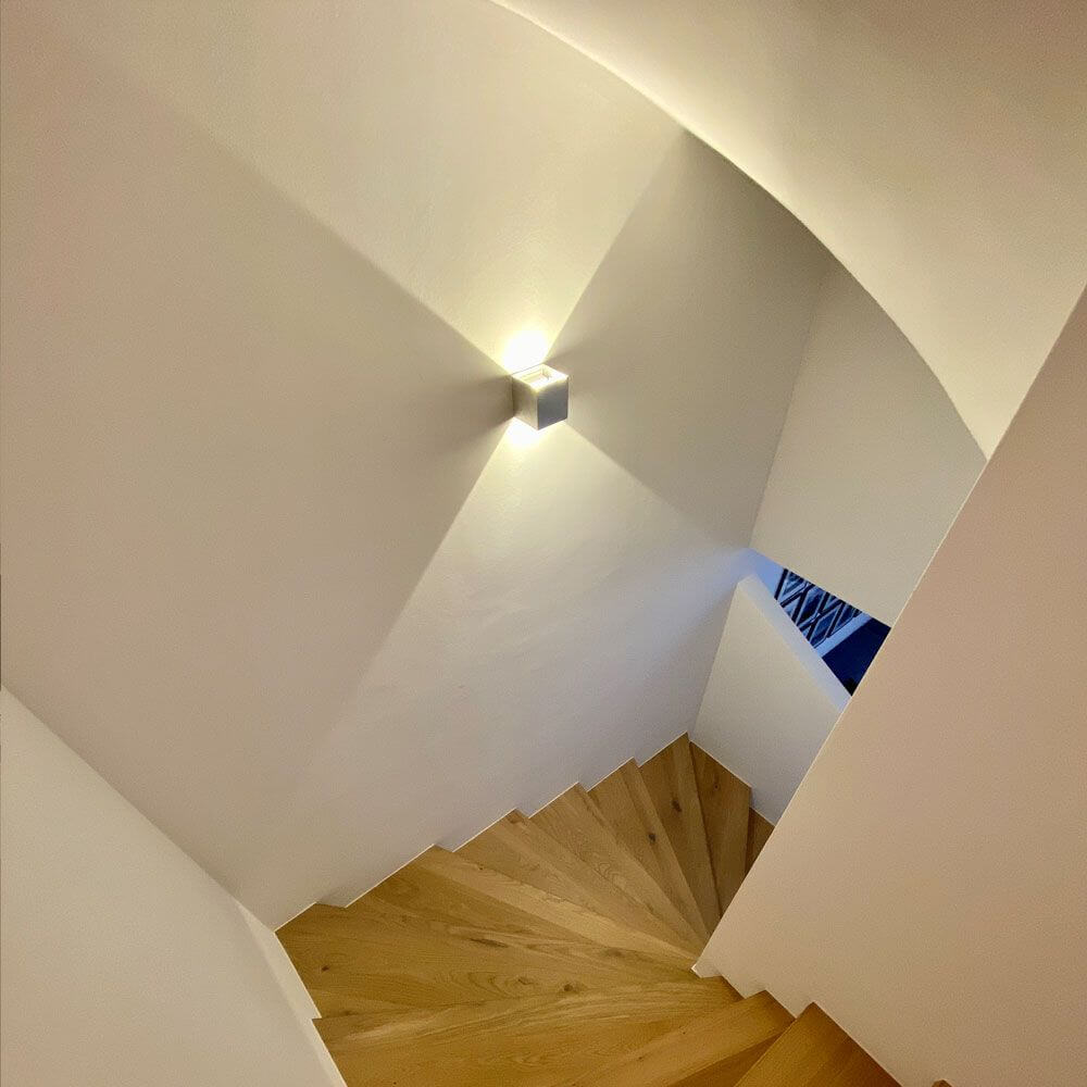 s.luce Ixa LED wandlamp met bewegingssensor aan een trap in een moderne interieur.