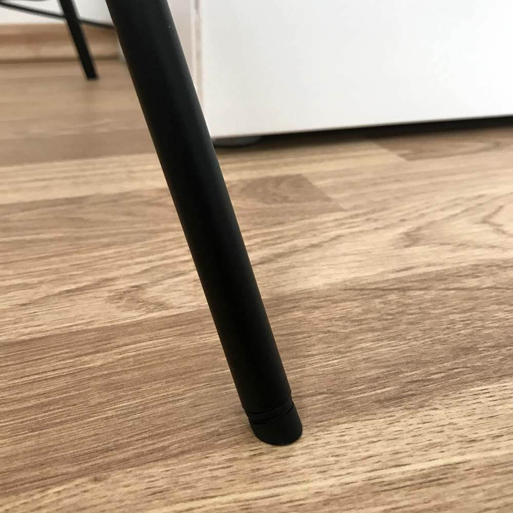 Nahaufnahme des Gestells der s.luce Stehleuchte Progress auf einem Holzfußboden.