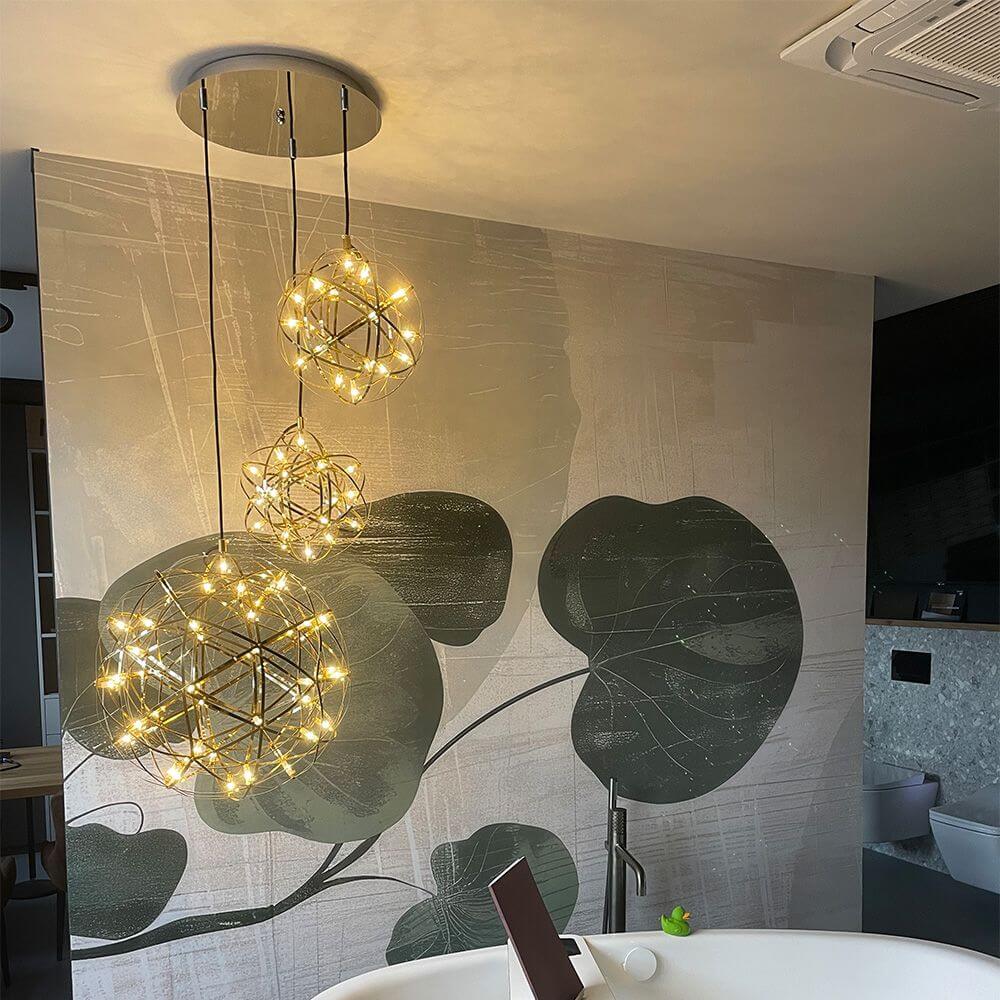 s.luce Atom LED pendant light dimmable in modern room with plant motifs, creates impressive light play.