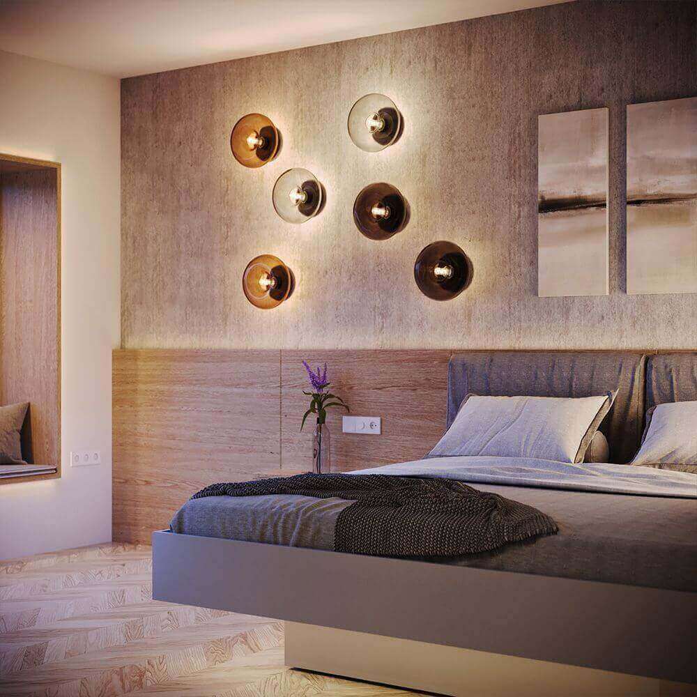 Modernes Schlafzimmer mit stilvollen Wandlampen und minimalistischer Einrichtung.