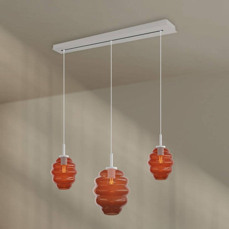 s.luce Echos Esstischlampe 3-flammig 120cm Ø 18/25cm mit orangefarbenen Glaskörpern am Baldachin.