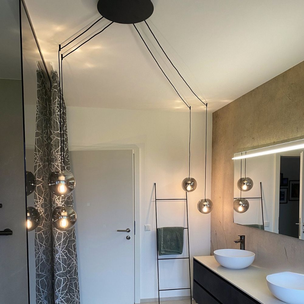 s.luce Orb glass ball pendant light in a modern bathroom with stylish design and bright light.