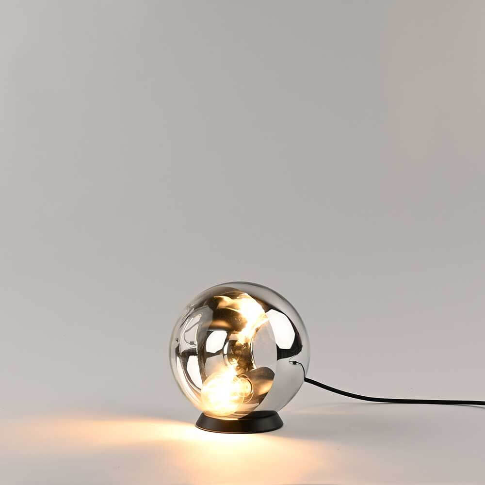 s.luce Orb Tischlampe mit gläserner Kugel und schwarzem Metallring, minimalistische Eleganz für modernes Wohnen.