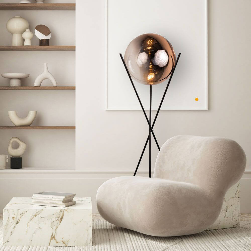 s.luce Stehleuchte Progress 40cm in modernem Interieur mit goldener Glaskugel und eleganter Dreibeinform.