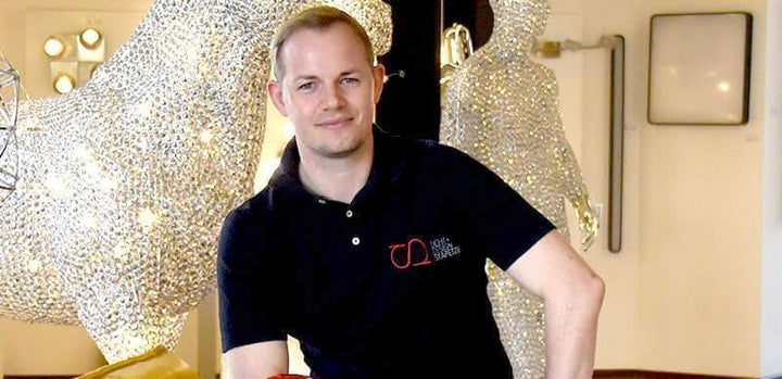 Shopware-Gewinner im April - Guido Huber von skapetze® im Interview mit glitzernden Skulpturen im Hintergrund.